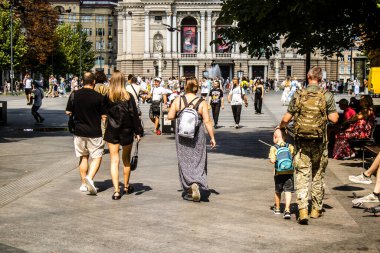 Lviv, Ukrayna, 18 Ağustos 2024 Lviv sakinleri ve turistler tarihi şehir merkezinde yürüyorlar. Ülke savaşta olmasına rağmen, çoğu işletme açık ve insanlar normal bir hayat yaşamaya çalışıyor..