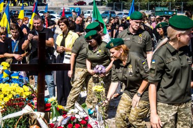 Lviv, Ukrayna, 29 Ağustos 2024 Mars meydanında, bir askeri mezarlık, askerler, silah arkadaşları, Rus ordusuna karşı savaşta ölen kendilerinden birinin mezarının önünde toplandı..
