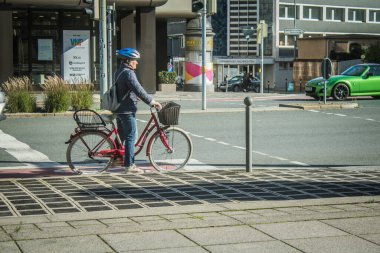 Nuremberg, Almanya, 10 Ekim 2024. Nuremberg 'den bir Alman vatandaşı bisikletini şehir merkezinde sürüyor. Bir ulaşım aracı olarak bisiklet Almanya 'da çok popülerdir..