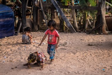 Kampong Phluk, Kamboçya, 15 Ocak 2025. Çocuklar Tonle Sap Gölü 'nde inşa edilen geleneksel yüzen köyde yaşıyorlar. Toplumun hayatta kalması büyük oranda balıkçılık ve turizme bağlı..