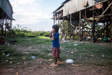 Kampong Phluk, Kamboçya, 15 Ocak 2025. Çocuklar Tonle Sap Gölü 'nde inşa edilen geleneksel yüzen köyde yaşıyorlar. Toplumun hayatta kalması büyük oranda balıkçılık ve turizme bağlı..