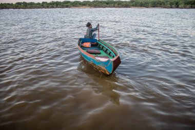 Kampong Phluk, Kamboçya, 15 Ocak 2025. Tekneler Tonle Sap Gölü 'nde inşa edilen geleneksel yüzen balıkçı köyüne açılır. Toplum büyük oranda hayatta kalmak için balıkçılık ve turizme bağımlıdır..