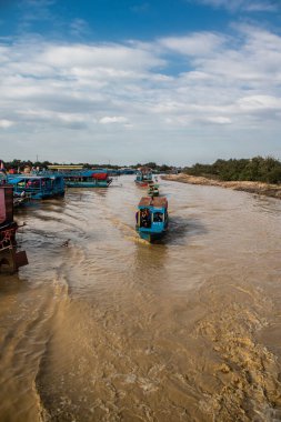 Kampong Phluk, Kamboçya, 15 Ocak 2025. Tekneler Tonle Sap Gölü 'nde inşa edilen geleneksel yüzen balıkçı köyüne açılır. Toplum büyük oranda hayatta kalmak için balıkçılık ve turizme bağımlıdır..