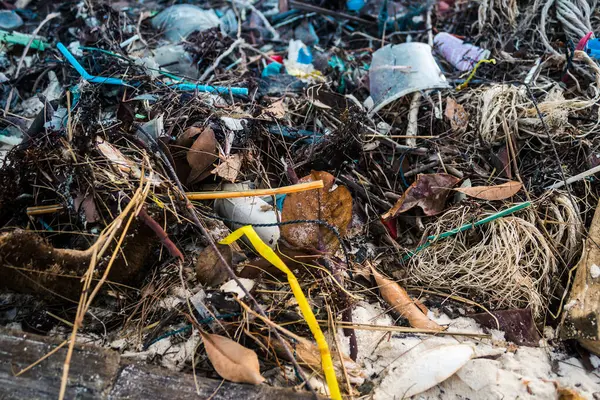 Close-up of a piece of plastic marine debris washed up on a sandy beach