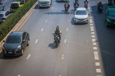 Bangkok, Tayland, Mart 06, 2025 Tayland 'ın başkenti Bangkok sokaklarında motosikletle gezen insanlar, hayat dolu sokak hayatlarıyla ünlüdür..
