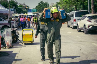 Bangkok, Tayland, 29 Mart 2025. Kurtarma ekipleri, Bangkok 'taki deprem sonrasında çöken, inşaat halindeki bir yüksek binanın şantiyesinde çalışıyor. Birçok kurban hala enkaz altında..
