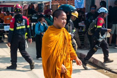 Bangkok, Tayland, 29 Mart 2025 Budist keşişler, Tayland 'ın başkentini vuran depremin ardından yıkılan ve inşaatı devam eden yüksek binadaki kurbanlar için dua etmeye gelirler..