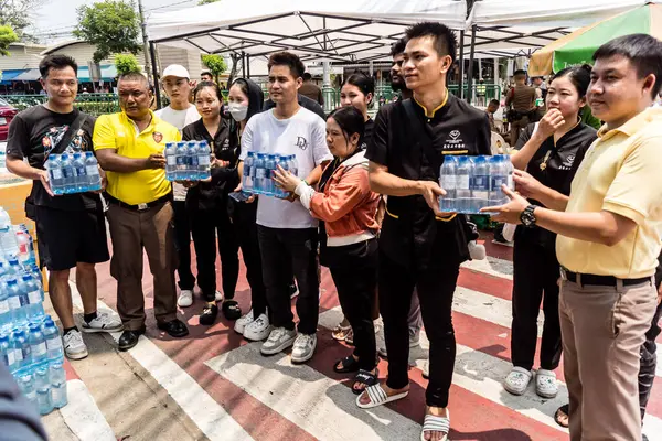 Bangkok, Tayland, 29 Mart 2025. Tayland başkentini deprem vurduktan sonra yıkılan yüksek binadaki kurtarma ekiplerine su ve yiyecek getiren gönüllüler..