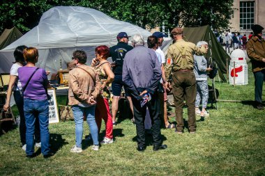 Reims, Fransa, 10 Mayıs 2025. Dünya Savaşı 'ndan kalma kostümlü insanlar, araçlar, silahlar, lojistik ve dönem aksesuarlarıyla 1945 Amerikan Müttefik askeri kampının tarihi yeniden canlandırmasını ziyaret etti.