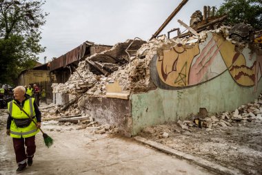 Kharkiv, Ukrayna, 12 Haziran 2025 Temizlikçiler bir Rus Shahed İHA 'sının çarptığı bir ev üzerinde çalışıyorlar. Hasar büyük, ev tamamen yıkılmış, yanmış ve çatısı sökülmüş..