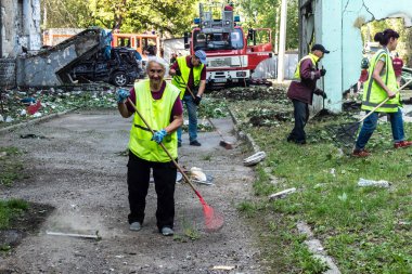 Kharkiv, Ukrayna, 7 Temmuz 2025 Temizlikçiler Kharkiv 'de bir Rus Şaban İHA' sının çarptığı bir bina üzerinde çalışıyorlar. Birçok apartmanın yanması ve pencerelerin tahrip olmasıyla hasar büyük oldu.