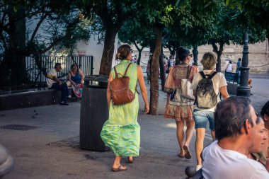 Seville, İspanya, 21 Eylül 2025 Sevilla şehir merkezinin tarihi bölgesini ziyaret eden turistler dar, pitoresk caddelerde yürüyorlar..