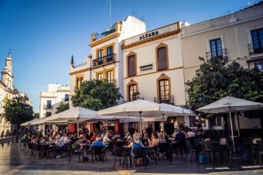 Seville, İspanya, 21 Eylül 2025 Sevilla şehir merkezinin tarihi bölgesini ziyaret eden turistler dar, pitoresk caddelerde yürüyorlar..