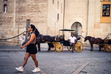 Seville, İspanya, 21 Eylül 2025 Sevilla şehir merkezinin tarihi bölgesini ziyaret eden turistler dar, pitoresk caddelerde yürüyorlar..