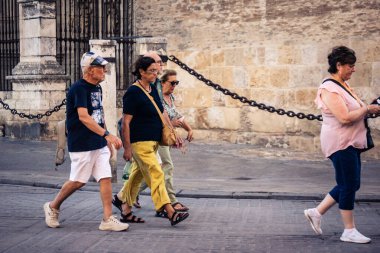 Seville, İspanya, 21 Eylül 2025 Sevilla şehir merkezinin tarihi bölgesini ziyaret eden turistler dar, pitoresk caddelerde yürüyorlar..