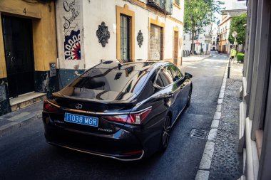 Seville, İspanya, 21 Eylül 2025 Sevilla 'nın tarihi şehir merkezinden geçen arabalar dar, pitoresk caddelerden geçiyor..