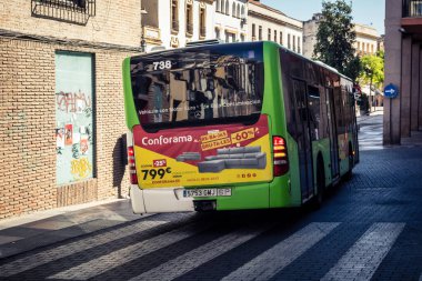 Cordoba, İspanya, 2 Ekim 2025. Otobüs Cordoba 'nın tarihi şehir merkezinde dar ve pitoresk sokaklardan geçiyor. Otobüsler Cordoba 'daki en popüler ulaşım araçlarından biridir..
