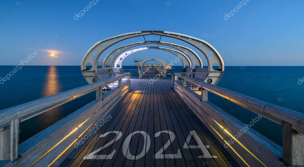 2024 written on the wooden planks of a pier. Happy new year 2024