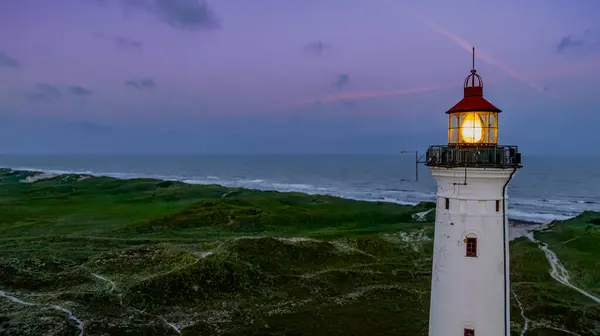 Lantern of lighthouse on wide dune with beach view on the west coast of Jutland, Denmark. 