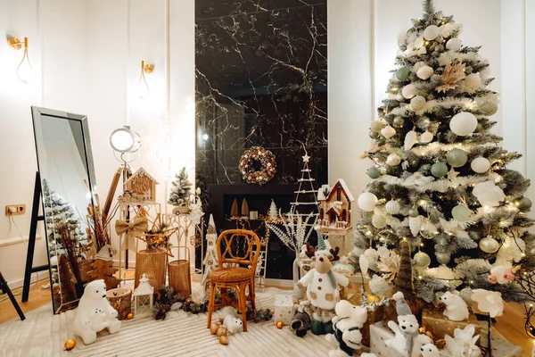 Christmas decor in living room with a Christmas tree, fireplace, gifts and toys. Scenic decor for photoshoots