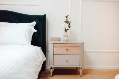 Furniture and accessories in modern bedroom of luxurious apartment