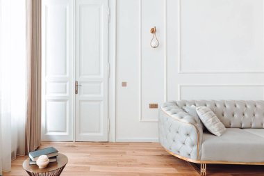 Interior design details - stylish modern furniture and wooden floors in residential home