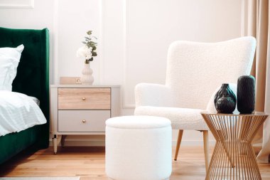 Beautiful bedroom interior with lounge chair, stylish and modern furniture