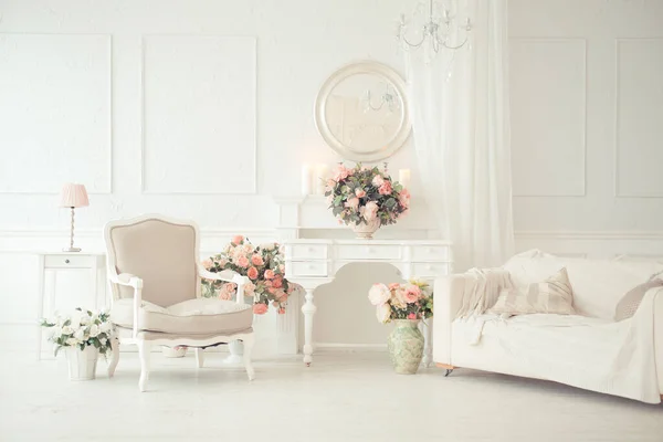 luxury clean bright white interior. a spacious room with sunlight and flowers in vases