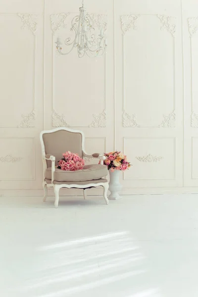 luxury clean bright white interior. a spacious room with sunlight and flowers in vases
