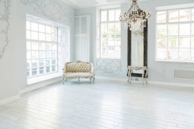 Lüks zengin oturma odası iç tasarım zarif klasik mobilyalar ve duvar süslemeleri ile. Büyük pencereli büyük ışık beyaz Oda