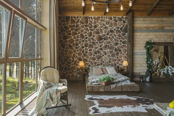 dark cozy interior of big country wooden house, wooden furniture and animal furs. huge panoramic window and very high ceiling.