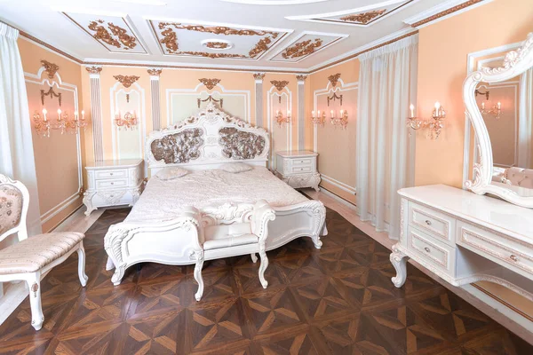 stock image small luxury bedroom with bath and expensive furniture in a chic old baroque style.