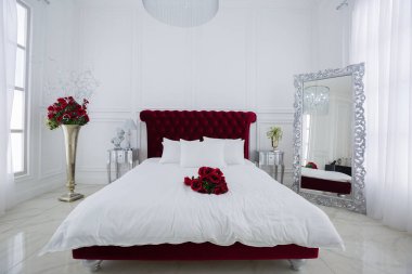 Lüks beyaz ışıklı yatak odası iç tasarımı. Koyu kırmızı büyük yatak