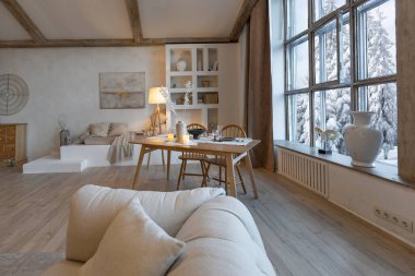 cozy warm home interior of a chic country chalet with a huge panoramic window overlooking the winter forest. open plan, wood decoration, warm colors and a family hearth clipart