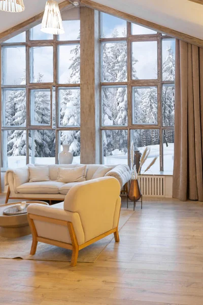 stock image cozy warm home interior of a chic country chalet with a huge panoramic window overlooking the winter forest. open plan, wood decoration, warm colors and a family hearth