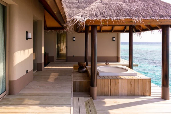 stock image Luxurious exterior of a very expensive rich water villa in the Maldives, decorated with natural wood.