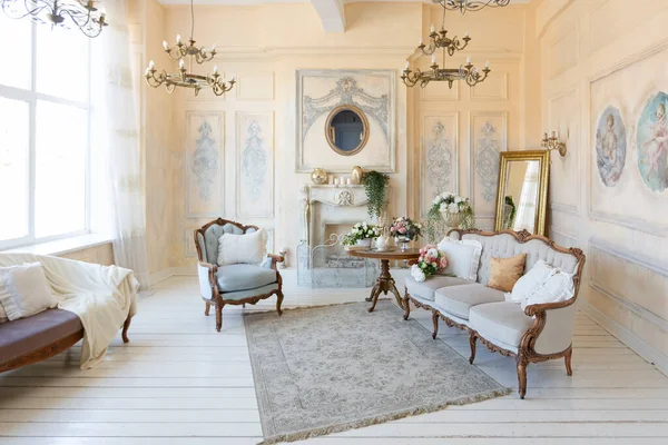 stock image luluxury rich sitting room interior in beige pastel color with antique expensive furniture in baroque style. walls decorated with stucco and frescoes