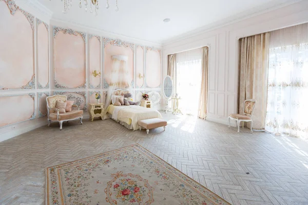 stock image Luxurious expensive interior design of the bed room in the old Baroque style in beige colors