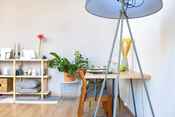 stock image interior of stylish loft. spacious apartment with large windows, parquet on the floor and light walls. closeup view of shelving with different small things for decoration