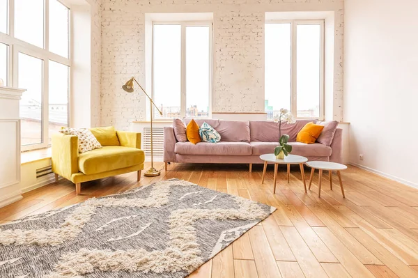 very light and spacious two-rooms apartment in Scandinavian design style with fashion furniture and large windows. warm colors during day time