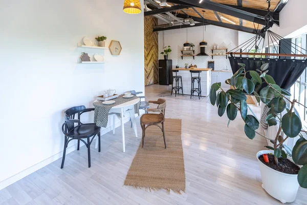 stock image stylish kitchen interior design. white walls and wooden decoration. beautiful hammock and high windows.