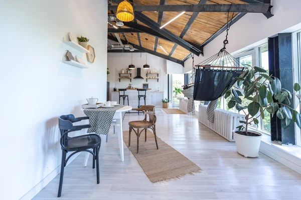 stock image stylish kitchen interior design. white walls and wooden decoration. beautiful hammock and high windows.