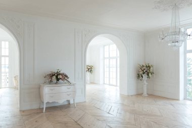 Pahalı antika mobilyaları olan büyük, şık bir salon. Barok iç tasarımı, duvarlarda süs ve yerde parke var..