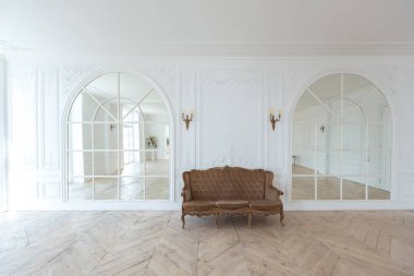 Pahalı antika mobilyaları olan büyük, şık bir salon. Barok iç tasarımı, duvarlarda süs ve yerde parke var..