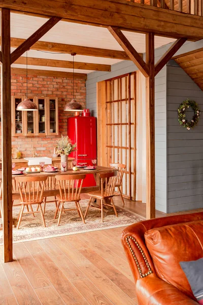 stock image cozy all wooden interior of a country house in a wooden design. spacious living room with kitchen area with large windows. bedroom on the second floor.