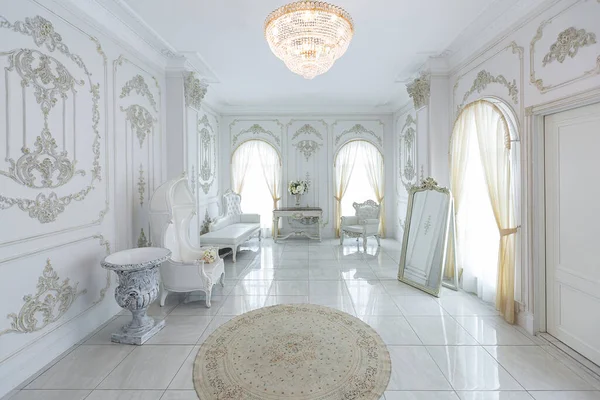 stock image luxury royal posh interior in baroque style. very bright, light and white hall with expensive oldstyle furniture. large windows and stucco ornament decorations on the walls