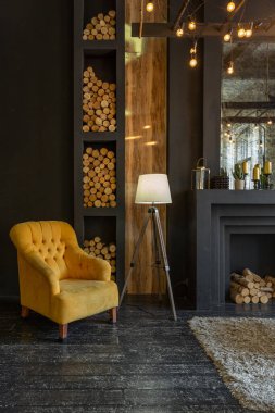 dark brutal interior of sitting room decorated with wooden logs. yellow and grey soft armchairs, huge arc window and fireplace clipart