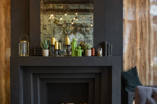 Oturma odasının içi tahtadan kütüklerle süslenmiş. sarı ve gri yumuşak koltuklar, büyük kavisli pencere ve şömine