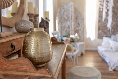 İki katlı, balkon tarzı dekoratif eşyalarla dolu, parlak bir dairede modern bir oda. Beyaz duvarlar, ahşap döşemeler ve eski mobilyalar.