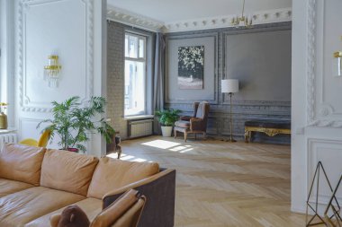 luxury interior of a spacious apartment in an old 19th century historical house with modern furniture. high ceiling and walls are decorated with stucco clipart